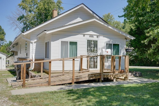 1040 Stone Ave, Independence, MO 64055 - rear view of house with a deck, a chimney, and a lawn