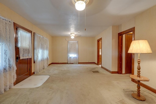 spare room featuring light colored carpet