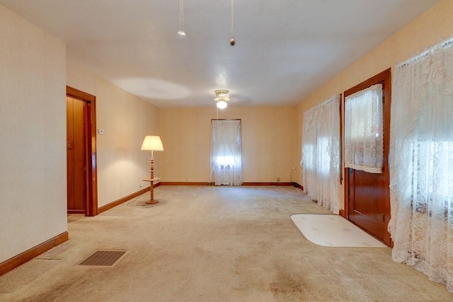 1040 Stone Ave, Independence, MO 64055 - spare room featuring light carpet, baseboards, and ceiling fan