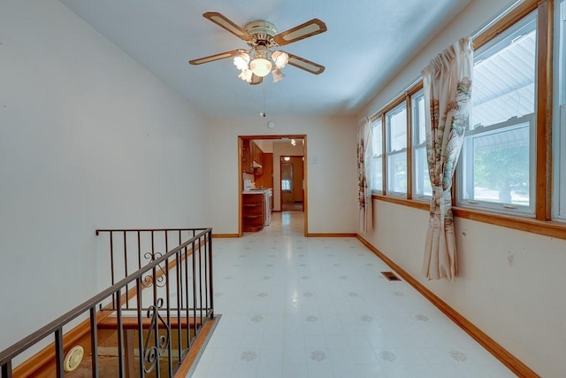 1040 Stone Ave, Independence, MO 64055 - hall featuring an upstairs landing, light floors, and baseboards