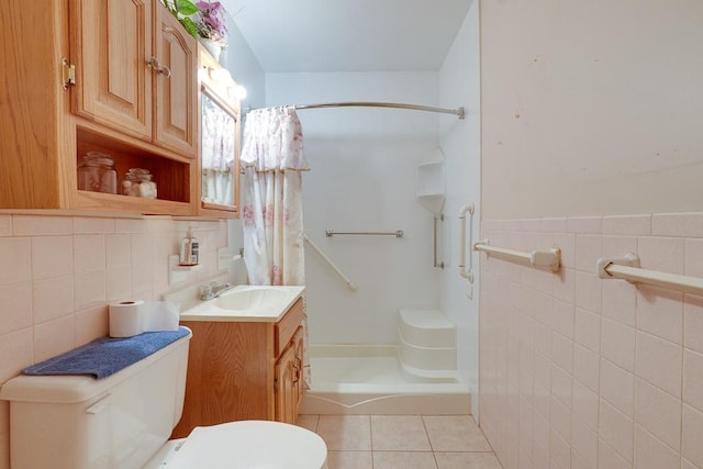 bathroom with vanity, a shower with shower curtain, tile walls, toilet, and tile patterned floors