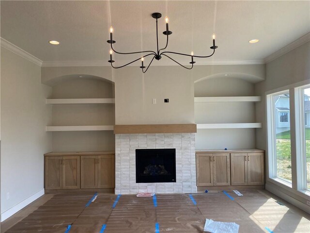 2914 NE 102nd St, Kansas City, MO 64155 - unfurnished living room with baseboards, built in shelves, a chandelier, and crown molding