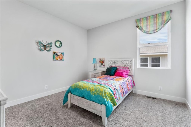 carpeted bedroom with visible vents and baseboards