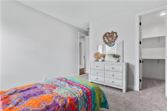 carpeted bedroom featuring a spacious closet