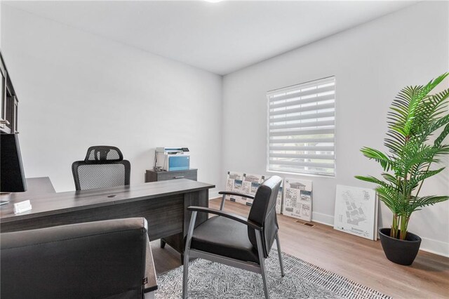 home office with wood-type flooring