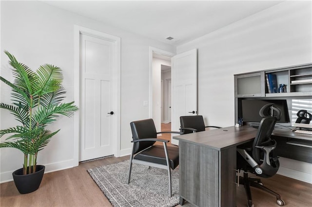 home office featuring baseboards and wood finished floors