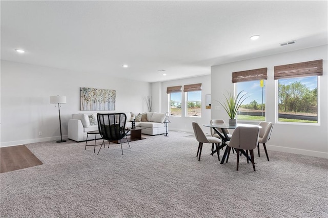 carpeted dining space featuring recessed lighting, visible vents, and baseboards