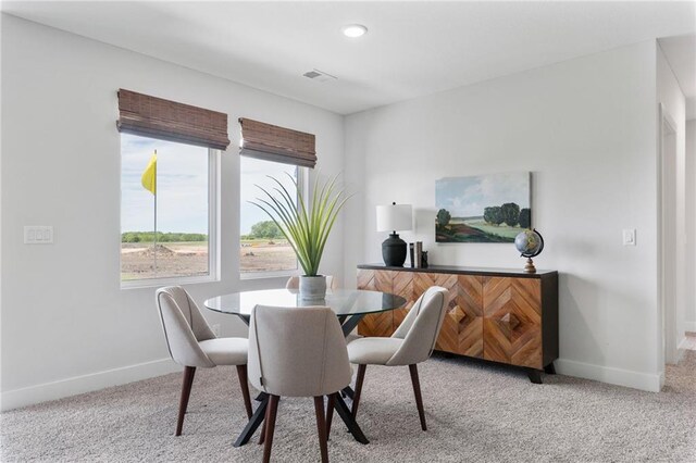 dining area featuring light colored carpet