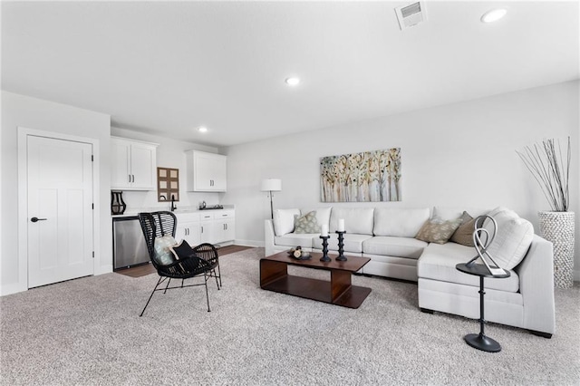 living area with baseboards, visible vents, and recessed lighting