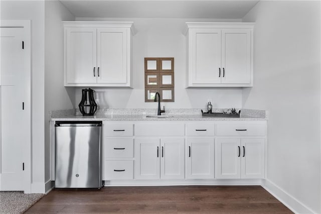 bar featuring dishwasher, sink, dark hardwood / wood-style floors, and white cabinetry