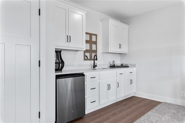 kitchen featuring light stone counters, dark wood-type flooring, white cabinetry, baseboards, and fridge