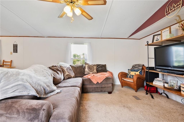 carpeted living area with ceiling fan and vaulted ceiling