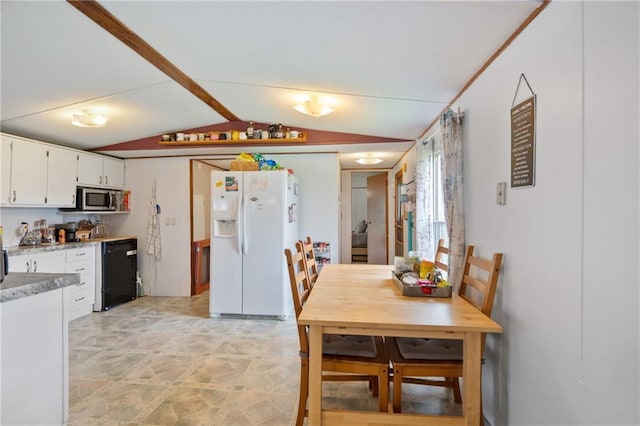 dining space featuring vaulted ceiling