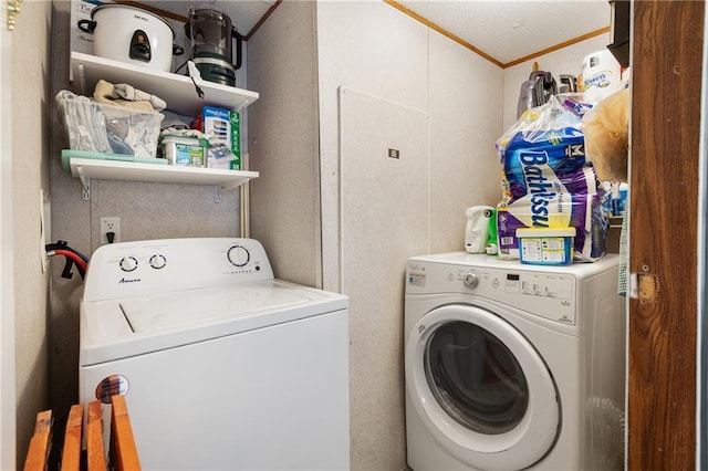 laundry room featuring laundry area, washer and clothes dryer, and crown molding