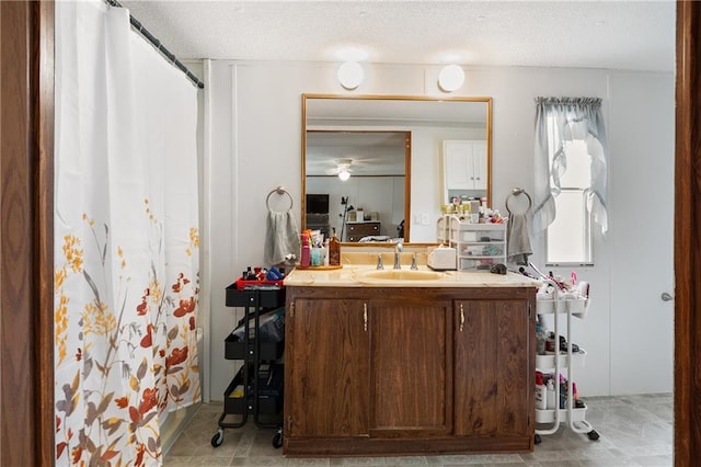 full bath featuring a textured ceiling, vanity, and a shower with curtain