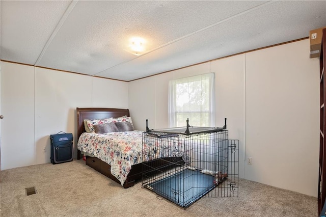 bedroom featuring carpet, visible vents, a textured ceiling, and ornamental molding