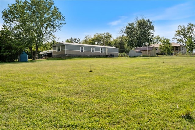 view of yard featuring an outbuilding and a storage shed