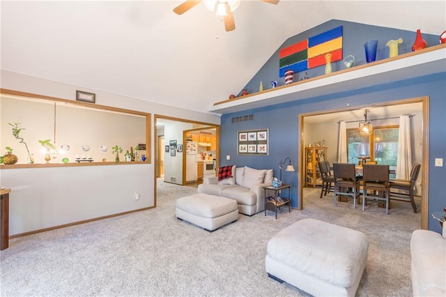 carpeted living area featuring visible vents, baseboards, high vaulted ceiling, and a ceiling fan