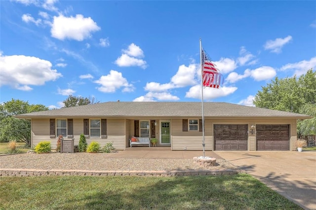 ranch-style home with a porch and a garage