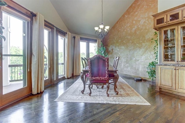 dining room with a chandelier, dark wood-type flooring, and vaulted ceiling