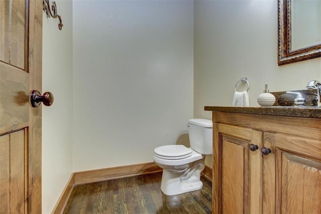 bathroom featuring hardwood / wood-style flooring, vanity, and toilet