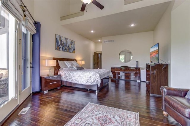 bedroom featuring dark hardwood / wood-style floors, high vaulted ceiling, and ceiling fan