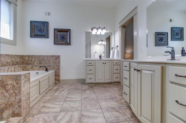 bathroom featuring a washtub and vanity