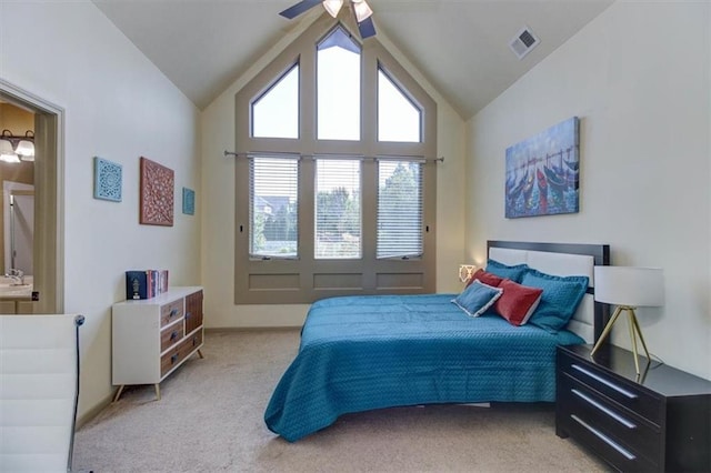 carpeted bedroom featuring ceiling fan and high vaulted ceiling