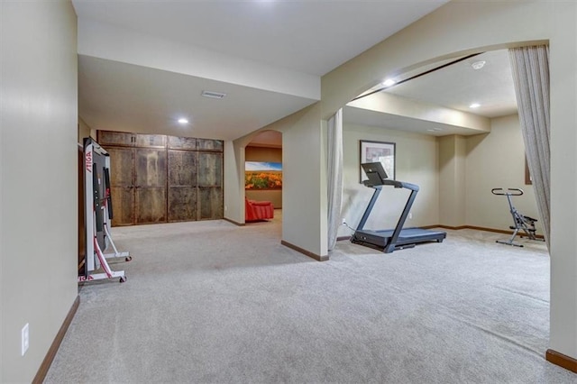 exercise room with light carpet