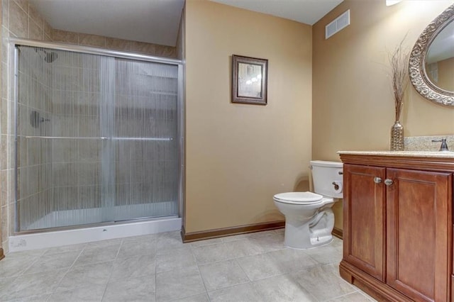 bathroom with tile patterned flooring, vanity, toilet, and an enclosed shower