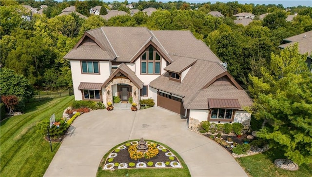 view of front of property with a garage and a front lawn