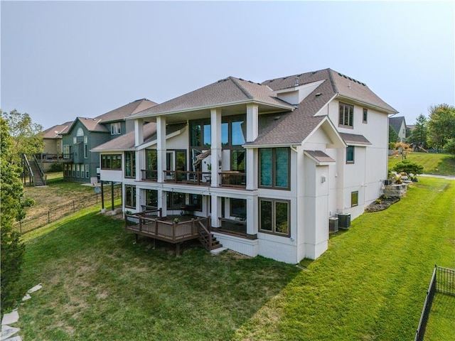 rear view of property featuring a wooden deck, a yard, and central AC unit