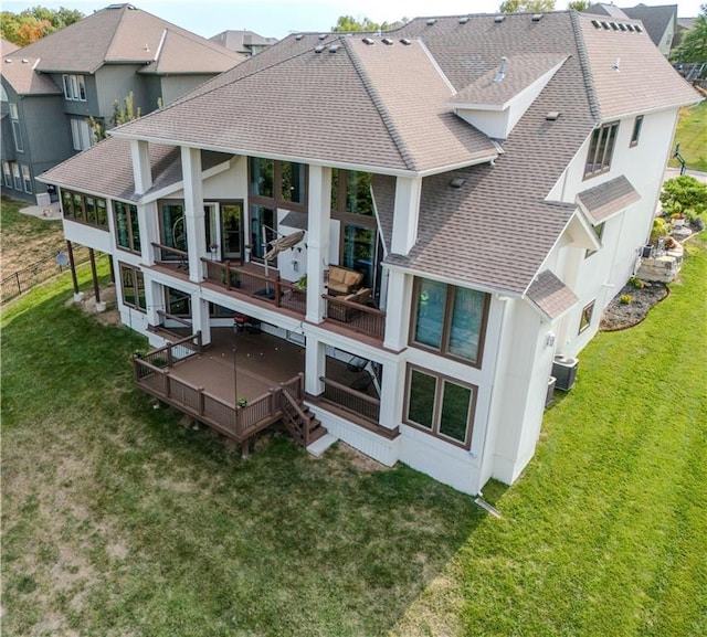 back of house with a lawn and central AC unit