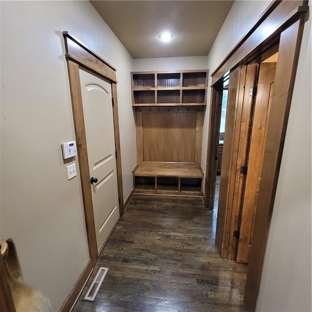 mudroom featuring a textured ceiling and dark hardwood / wood-style floors