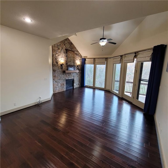 unfurnished living room featuring ceiling fan, a fireplace, dark wood-type flooring, and vaulted ceiling