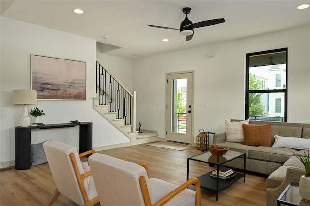 living room featuring ceiling fan and light wood-type flooring