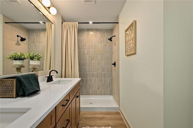 bathroom with vanity, hardwood / wood-style floors, and curtained shower