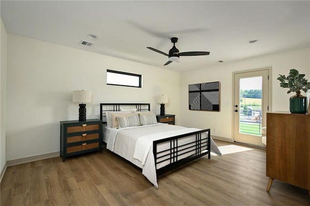 bedroom with access to outside, wood-type flooring, and ceiling fan