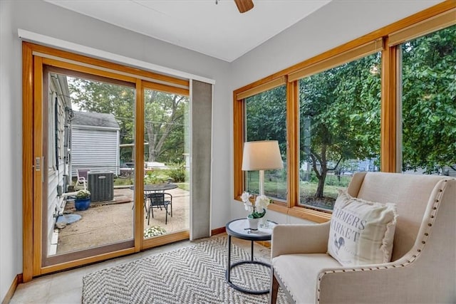 doorway featuring light tile patterned flooring, plenty of natural light, and ceiling fan