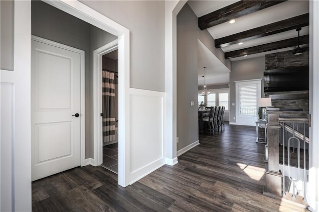 hall featuring dark hardwood / wood-style floors and beamed ceiling