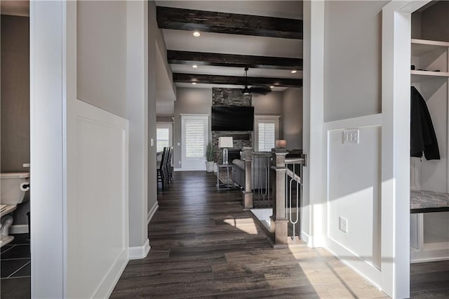 hall with dark hardwood / wood-style flooring and beam ceiling