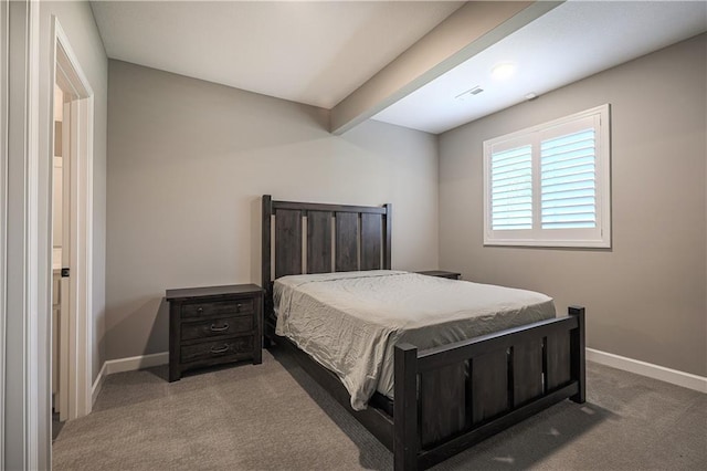 bedroom with beamed ceiling and carpet floors