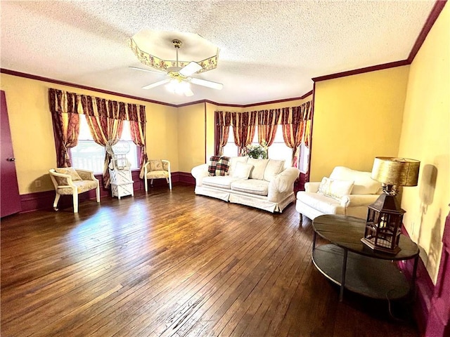 interior space featuring ornamental molding, multiple windows, ceiling fan, and hardwood / wood-style flooring