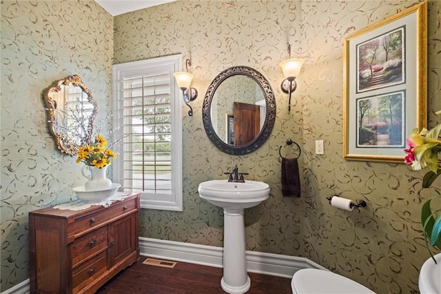 bathroom with wood-type flooring and toilet