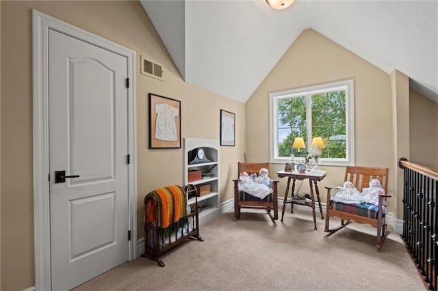 living area featuring light colored carpet and vaulted ceiling