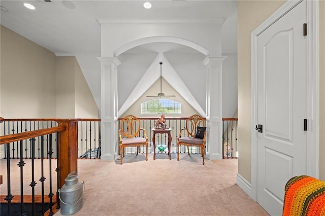 interior space featuring light colored carpet, ceiling fan, ornamental molding, and decorative columns