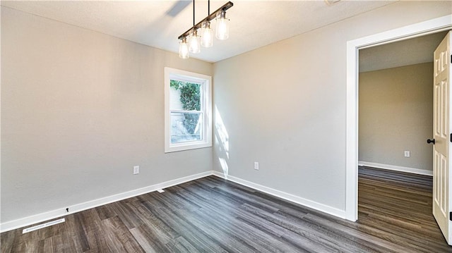 unfurnished room with dark hardwood / wood-style flooring