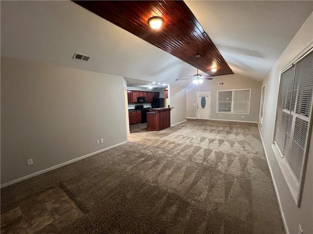 interior space with wooden ceiling, carpet flooring, black refrigerator, and ceiling fan