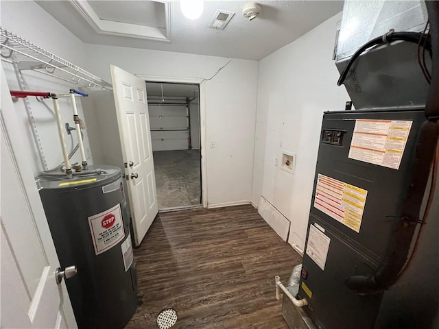 utility room with heating unit and electric water heater