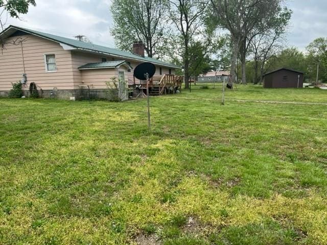 view of yard featuring a wooden deck